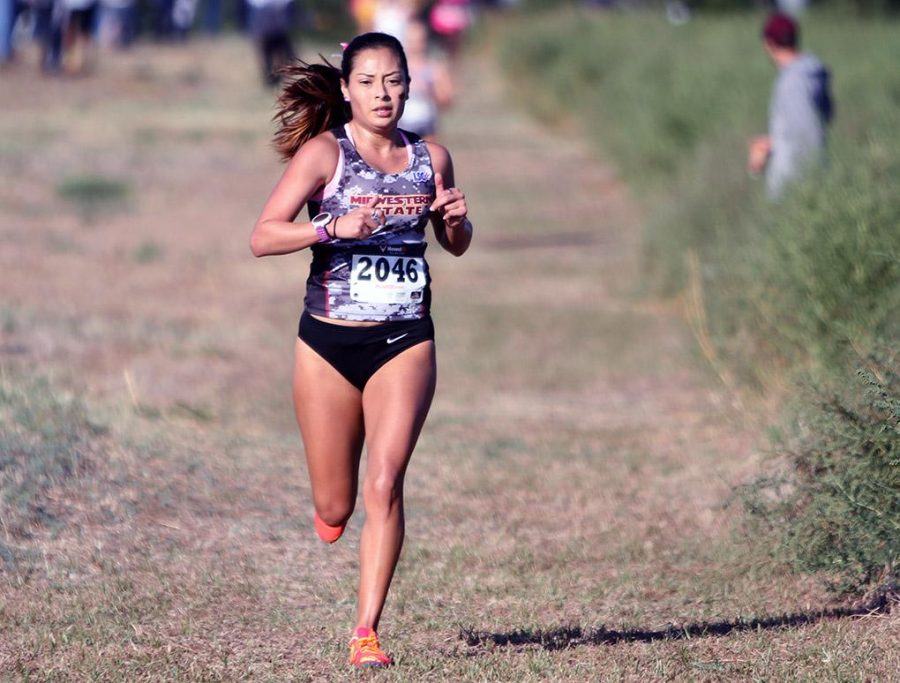 Gabby Ruiz, Spanish and nursing senior, runs in the Cross Country Carnival Saturday at the former Hawk Ridge Golf Course. Ruiz finished in second place with a personal-best of 22:20. Photo by Lauren Roberts