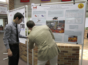 Alejandro Hernandez and Taylor Duval, mechanical engineering seniors, set up their poster April 24 at the EURECA Poster Presentations in the Clark Student Center Atrium. File Photo by Lauren Roberts.