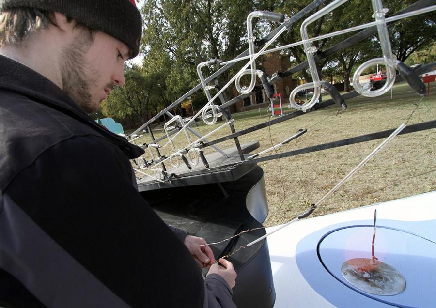 Daniel Dubose, mechanical engineering junior, works on the Skaters Table and Piano Friday on the lawn in front of the Hardin Administration Building. Dubose is a student worker for Midwestern State Universitys electrician department and this is his third year working on the MSU-Burns Fantasy of Lights display. The display will open Nov. 24 and run through Dec. 28, 2014. Photo by Lauren Roberts
