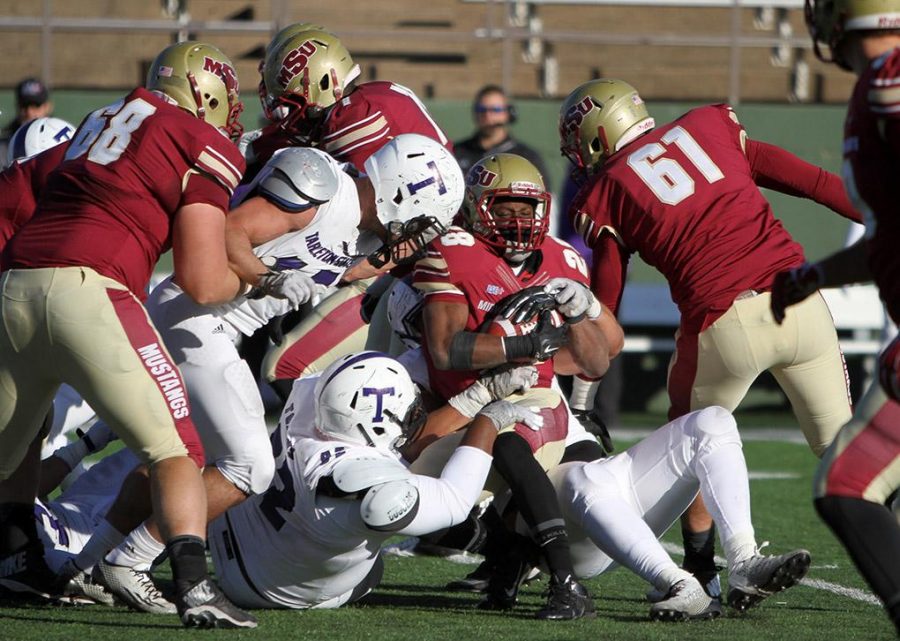 Dante Taylor, kinesiology sophomore, is tackled in the game between Midwestern State University and Tarleton State University Saturday Nov. 15, 2014 at Memorial Stadium. Photo by Lauren Roberts