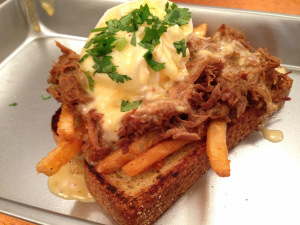 The Texas Benny: Jalapeño toast topped with fries, Dr Pepper pulled pork, poached egg and hollandaise sauce.