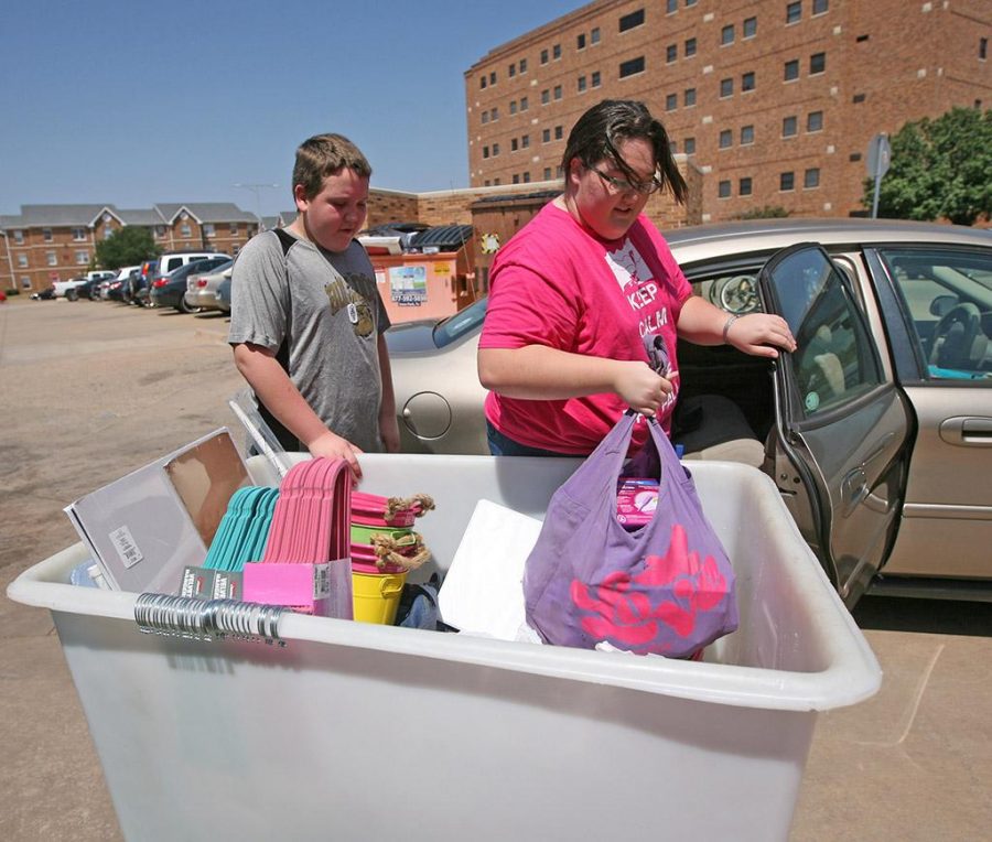 Ashley Roberts, a freshman in biology, unloads her things with her brother, Robinsion Roberts. Photo By Yasmin Persaud