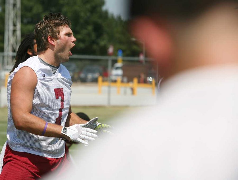 Linebacker Daniel Laudermilk, a senior in history, yells with other football players on one of the first full days of practice, Aug. 13. Photo by Bradley Wilson.