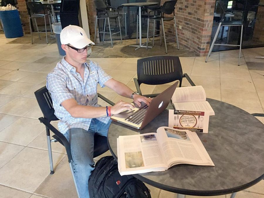 Caleb Nichols, business management junior, studies for an upcoming arts and culture test in the Dillard College of Business Administration. Photo by Bryson Petersen