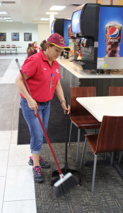 Velia Lozano, custodian in the Clark Student Center, sweeps the food court in the Mesquite Dining Hall on Sept. 22. Photo by Gabriella Solis
