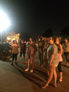 Alyvia Nichols, junior in early education, and some 20 others stand outside Moffett Library watching the Super Moon, Sept. 24. Photo by Taylor Courtney.