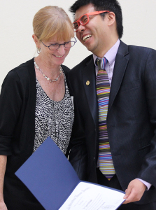 Newman Wong, chapter adviser, laughs with newly inducted honorary member Karen Polvado, an associate professor of nursing at the induction ceremony Sept. 18. Photo by Rachel Johnson.