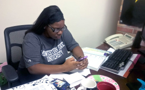Shayla Owens, junior in business management and student assistant in the Student Government's Association, sends out tweets to students. Photo by Melissa Laussmann