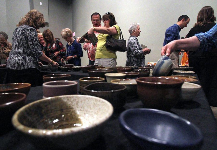 Attendees choose their bowl at the Empty Bowls event at the WIchita Falls Muesum of Art at MSU Tuesday afternoon. Photo by Lauren Roberts