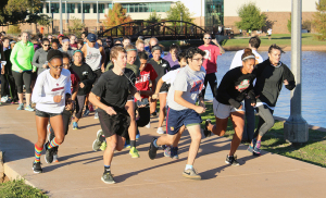 Caleb Hannon, assistant director of rec sports and Wellness center, sounds off for participants to begin running in the Turkey Trot 5K around Sikes Lake Nov. 17. The entry fee was one canned food item. Winners won a frozen turkey. Photo by Francisco Martinez