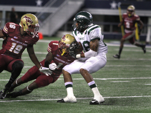 Eastern New Mexico running back Jordan Wells is tackled by Marqui Christian, criminal justice junior, at the  Midwestern State University v. Eastern New Mexico game at AT&T Cowboys Stadium in Arlington, Sept. 20, 2014. File photo by Lauren Roberts