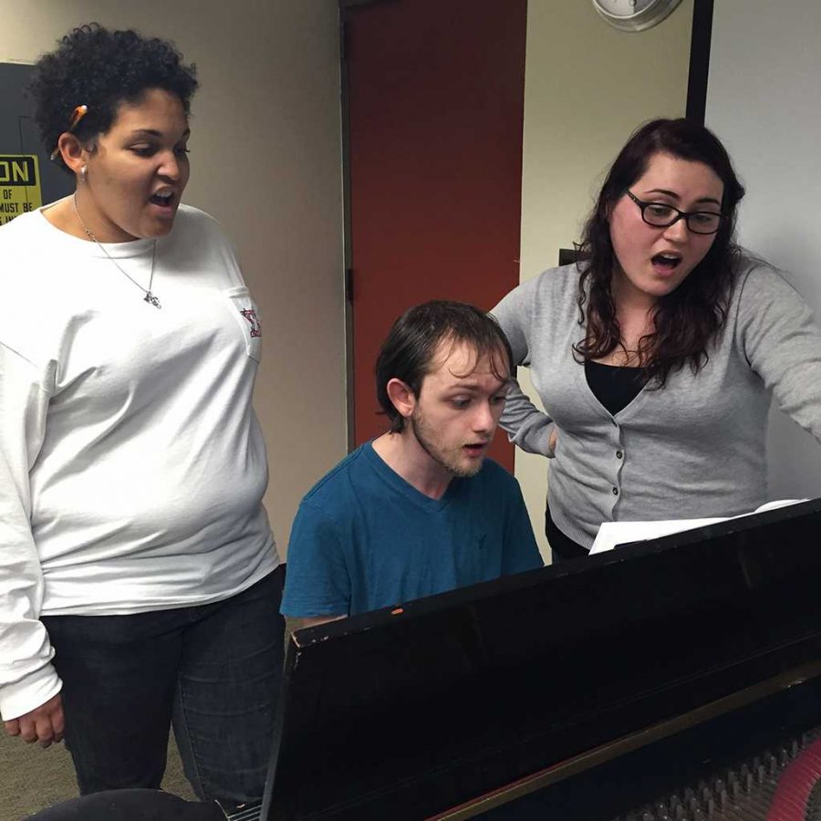 Whitney Hogue, vocal education junior, Matt Kohler, vocal education junior, and Alexis Goodman, vocal performance senior, practice one of the pieces for the upcoming Dec. 6 concert. Photo by Yvette Ordonez.