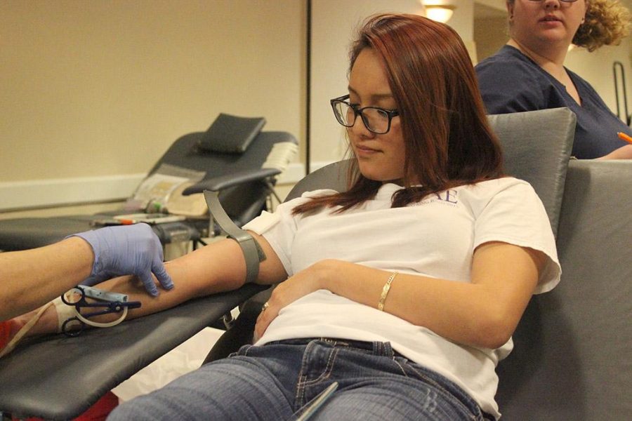 Estefani Villar, dental hygiene freshman, takes in a deep breath as a phlebotomist inserts a needle to draw blood in the Comanche suite, Jan, 26, 2016. Photo by Francisco Martinez