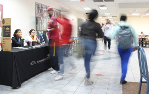 Students walk through the Clark Student Center during lunch rush hour, stopping for food, at the booths set up, trying to rush to class, or hanging out with friends, Feb. 16. Photo by Rachel Johnson