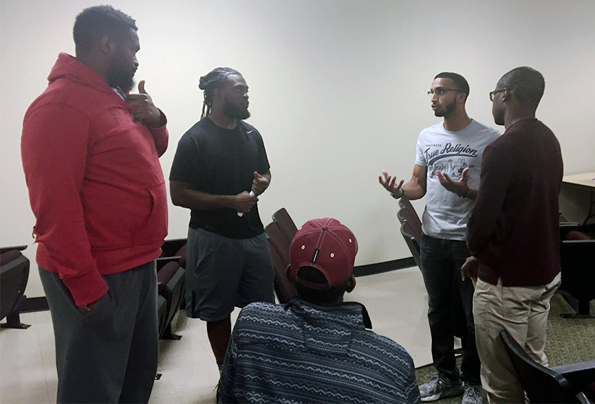 Brandon Gordon, kinesiology senior, Jalal Elrosoul, exercise physiology junior, and other students discussing the topic, Evolution of Bitch, after the NAACP meeting. Photo by Samuel Sutton