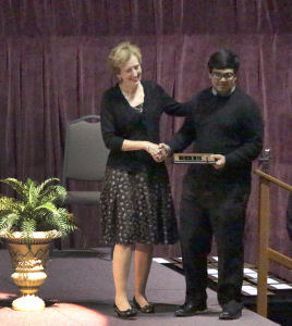 Rahul Joshi, finance freshman, is awarded the Outstanding Freshman Man award by University President Suzanne Shipley at the Honors Recognition Banquet in the D.L. Ligon Coliseum on April 22. Photo by Kayla White.