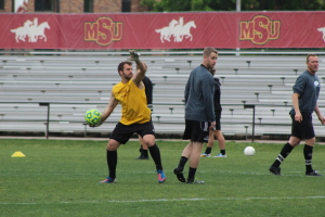 Noah Fazekas, mass communication junior, throws the ball back to some players during Alumni Week, in the Midwestern State Soccer Fields. Photo by Harley Warrick