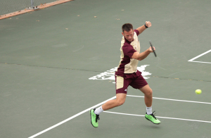 Kyle Davidson, accounting and finance senior, hits a tennis ball just served at the MSU men's tennis vs. Colorado Mesa tennis match on March 13 at the MSU tennis courts, later winning 8-1 overall. Photo by Kayla White.