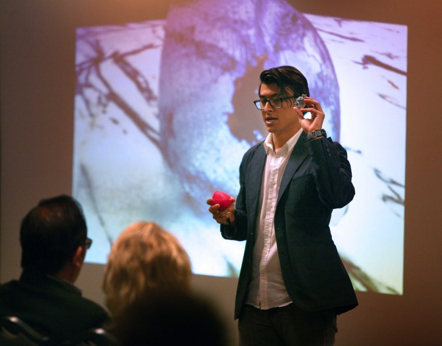 Michael Olaya discusses a three-dimensional printer than can print body parts at the Undergraduate Research and Creative Activities Forum, April 28, 2016. Photo by Bradley Wilson