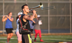 Adam McGee, music sophmore, practices trumbone on the field during band practice Aug. 24, 2016. Photo by Justin Marquart.