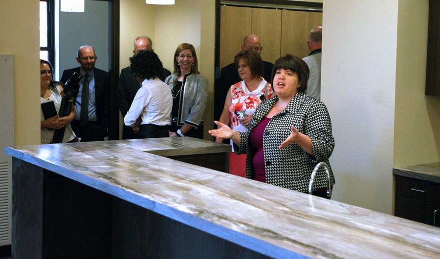 Kristi Schulte, housing director, gives details about the faculty-in-residence apartment in Legacy Hall to the Board of Regents during a walk-through on Aug. 4. Photo by Dewey Cooper.