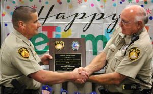 Chief Patrick Coggins presents Elwyn Ladd, police officer, with a plaque honoring his service with both MSU and the Wichita Falls Police Department. Photo by Jeanette Perry.