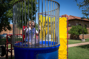 Morgan White, psychology sophomore, sits on the dunking booth during Roundup Olympics on the Quad Aug. 24. "The water wasn't cold," she said. "It feels uncomfortable being in the water in front of everybody." Photo by Izziel Latour