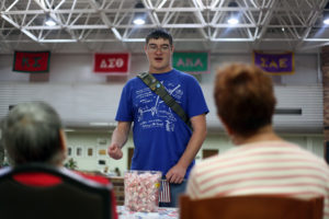 Braeden Alves mechanical engineering freshman discusses voter registration with the League of Woman Voters representatives. "I love America because the freedom to vote and of course free mints!" Spetember 16, Photo by Topher McGehee