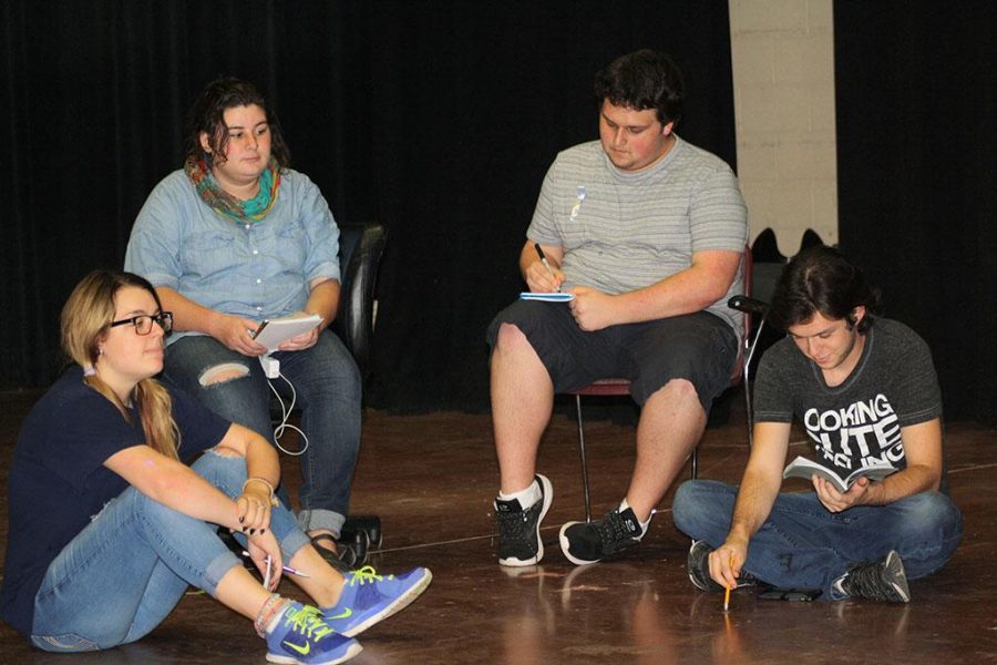 Sarah Dempsey, theater sophomore, Hope Harwick, theater junior, Dean Hart, theater sophomore, and Joey McGrinn, theater sophomore, listen to notes during rehearsal for Speech and Debate, Sept. 15. Photo by Brendan Wynne
