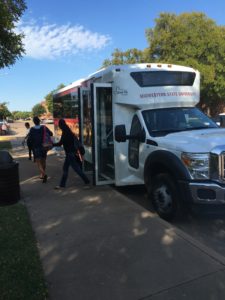 Students exiting campus shuttle 