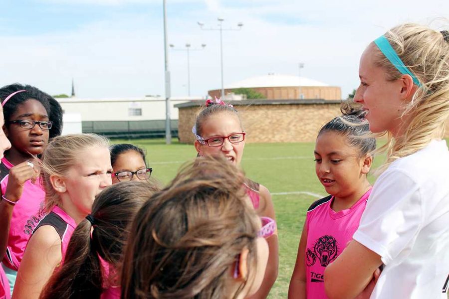 Madison Davis, criminal justice freshman, speaks with girls from the Pink Tigers soccer team.