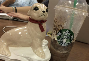 Robert, the ceramic seal, poses for a photo with his favorite drink. His handler, Ryan Lee, sophomore in psychology, says Robert always enjoys studying with friends. Photo by Ryan Lee.