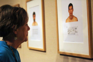 Emily LaBeff, sociology professor, reads one of Kip Fulbeck's Hapa Project gallery photos in the Juanita Harvey Art Gallery on Nov. 11. Photo by Bridget Reilly