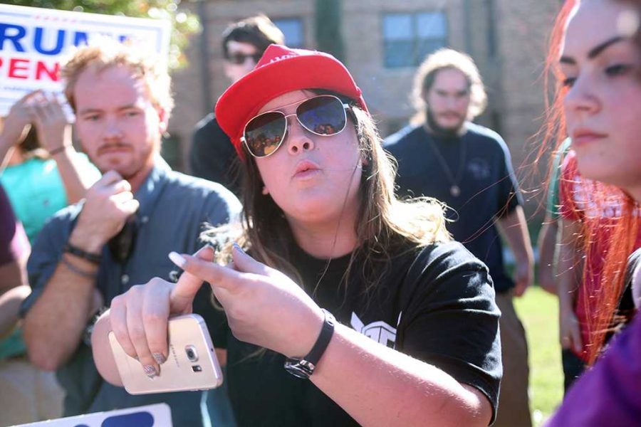 Gabriella Victoria, criminal justice, discusses, with the crowd of peaceful protesters, the advantages of having Donald Trump as president at a Nov 16 rally on campus. Members of a student group, PRIDE, said they plan another rally Feb. 1 at 2 p.m. outside Clark Student Center. Photo by Bridget Reilly