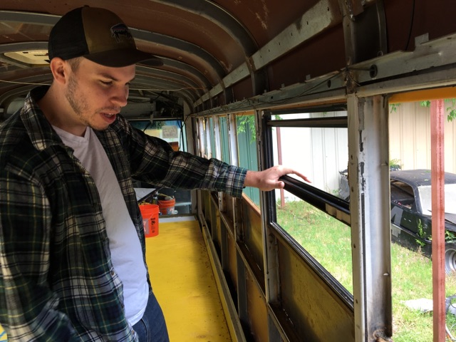Taylor Morrison, mass communication junior, has completely rebuilt and reconstructed the window frames of the steel bus to be double insulated for more comfort on his summer long trip accross the country. Photo by Cortney Wood