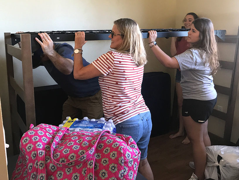 Malorie Lang, kinesiology freshman, and Emily Lang, radiology freshman, help to set up the beds in their new room. “The university made the transition so smooth. I’m so excited to get moved in.” Malorie said.
Photo by Sarah Graves