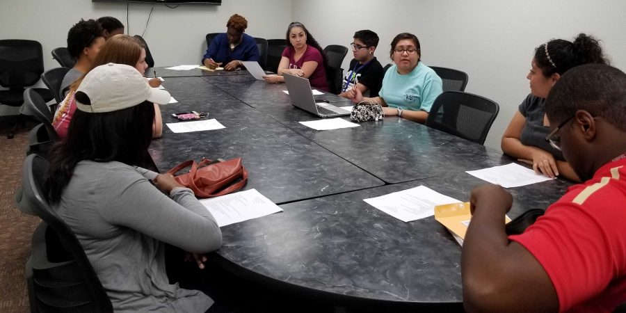 Selena Moreno (in teal), marketing and spanish junior and president of the Spanish club, addresses the club during their second meeting on Oct. 12 at the Clark Student Center.