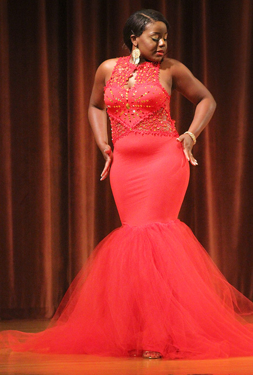 Valandra Jno Marie, management freshman, feels her hands down the curve of her dress during the evening wear portion of the 2017 Mr. and Miss Caribfest Pageant held in Akin Auditorium Sept. 28. Photo by Marissa Daley