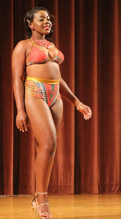 Valandra Jno Marie, freshman management, struts her orange patterened swimsuit for the bathing suit portion of the 2017 Mr. and Mrs. Caribfest in Akin Auditorium on Sept 28. Photo by Marissa Daley