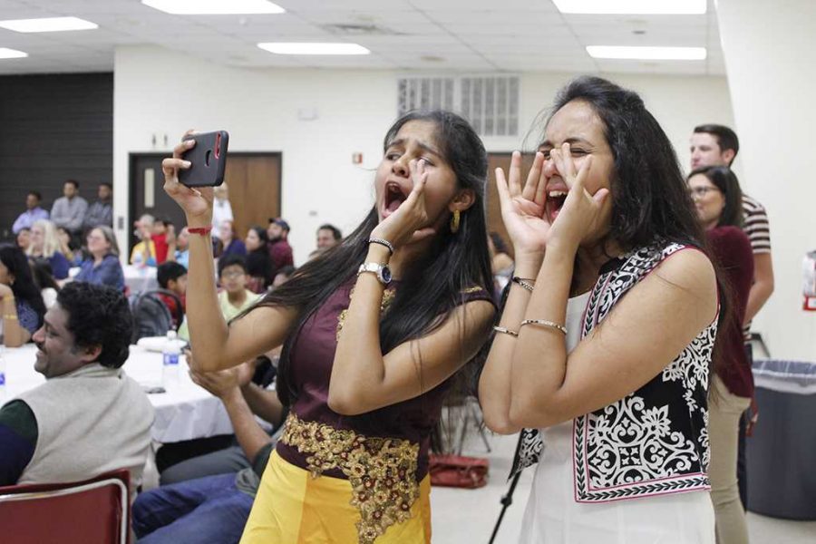 Abhilash Kolla, computer science senior, and Sindhu Thandra,computer science graduate student, yell and cheer on their friends during the traditional Diwali celebration, sat, Nov. 6, 2017, at the Sikes Lake Center. Photo by Sara Keeling