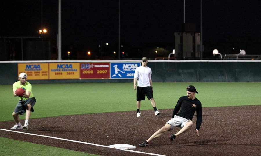 Jackson Strieby, mechanical engineering sophomore, slides to third base during the intramural kickball tournament at Mustangs Park on Feb. 23. In the first game of the three-game series, Kickball Team lost to Hometown Heroes 2-6. In the second game, Kickball Team beat Kindergarten Kickers 4-0. Photo by Timothy Jones