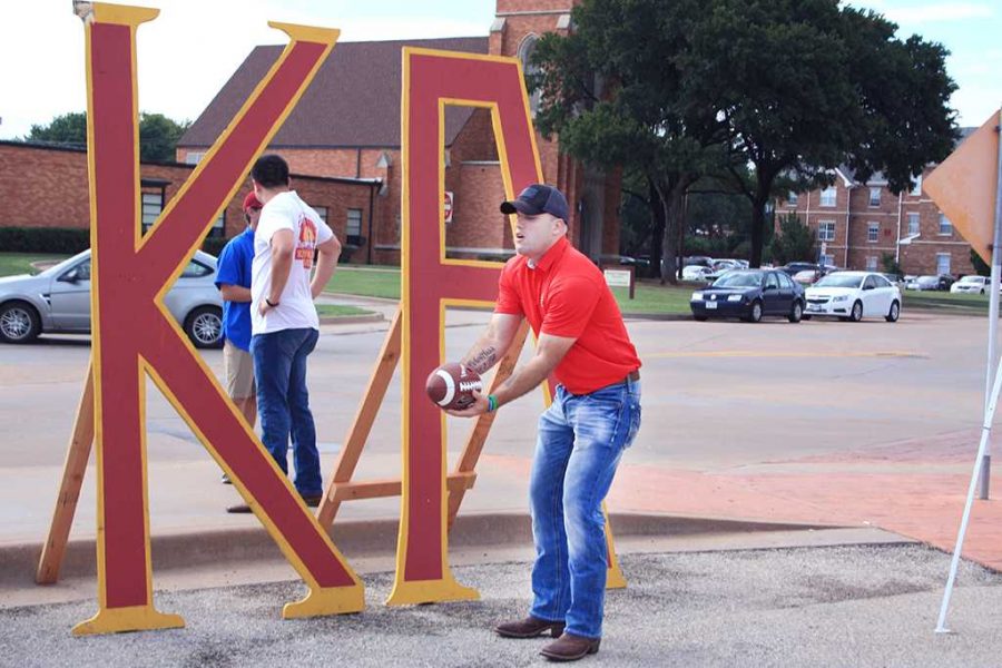 Kappa Alpha Orders D.J. Hauser, criminal justice senior, catches a football at the soccer tailgate in front of his fraternity’s letters on Aug. 24. 