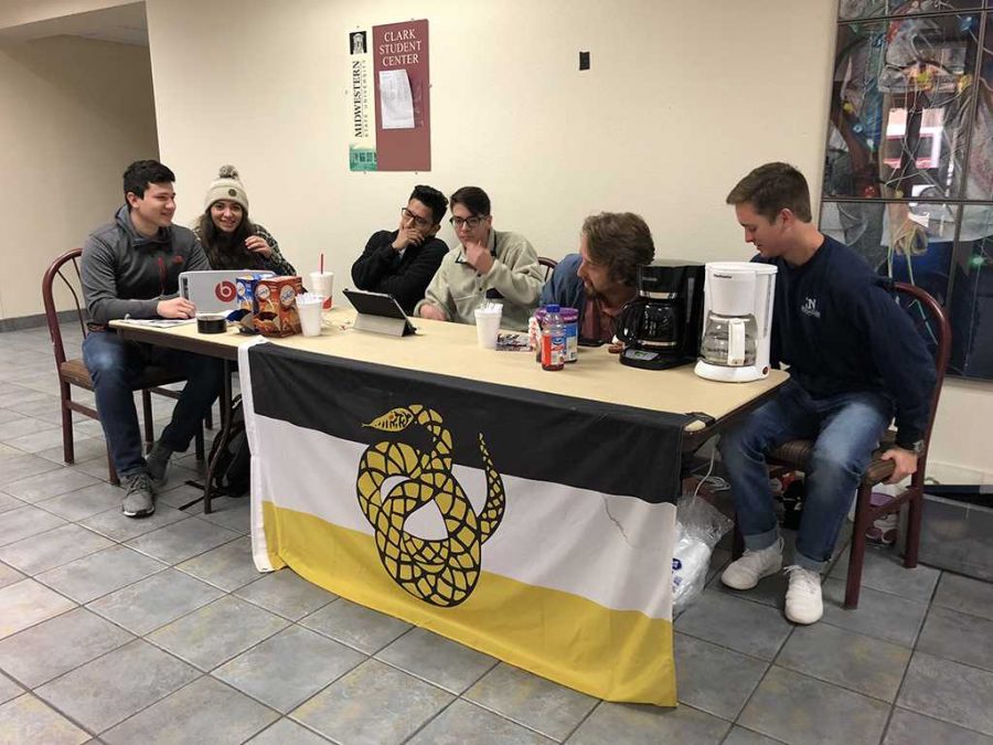 Members of Sigma Nu sell coffee and hot chocolate to raise funds Dec 6. Photo courtesy of Mia Heck.