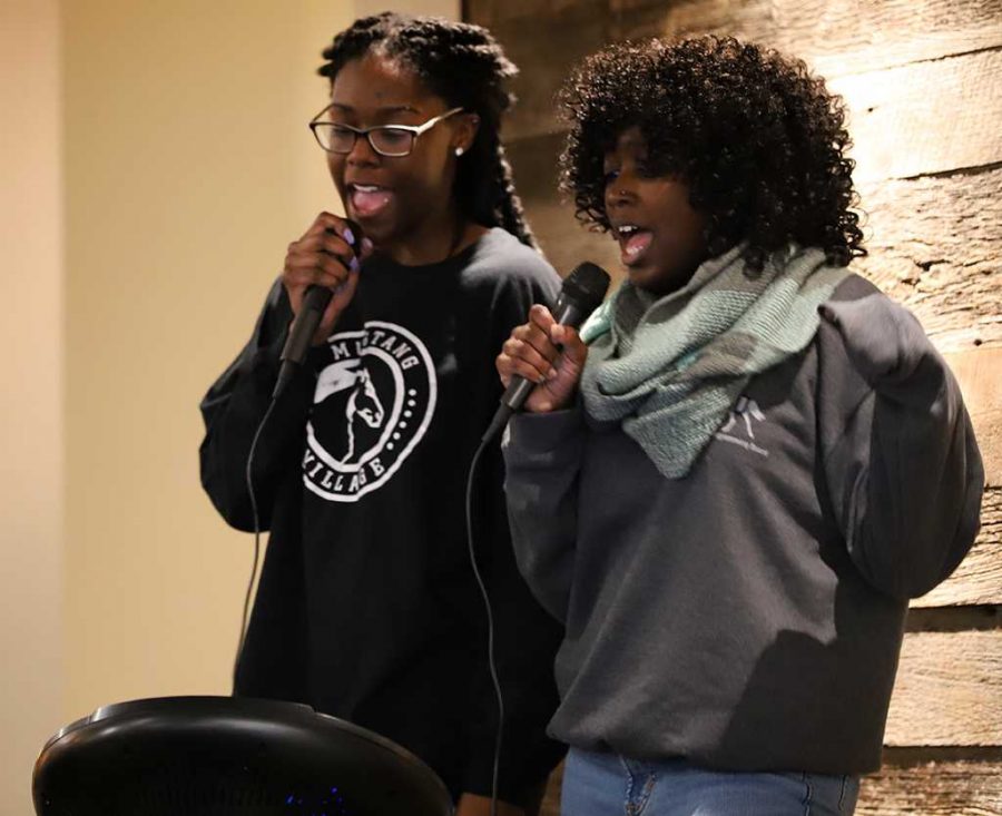 Anissia Jones, exercise physiology junior, and Taylor Barnett, mass communications junior, partake in the nacho karake event by singing the first cover song of the night in Mavericks Corner, hosted by MSUs University Programming Board, on Friday, Jan. 19, 2018. Photo by Harlie David