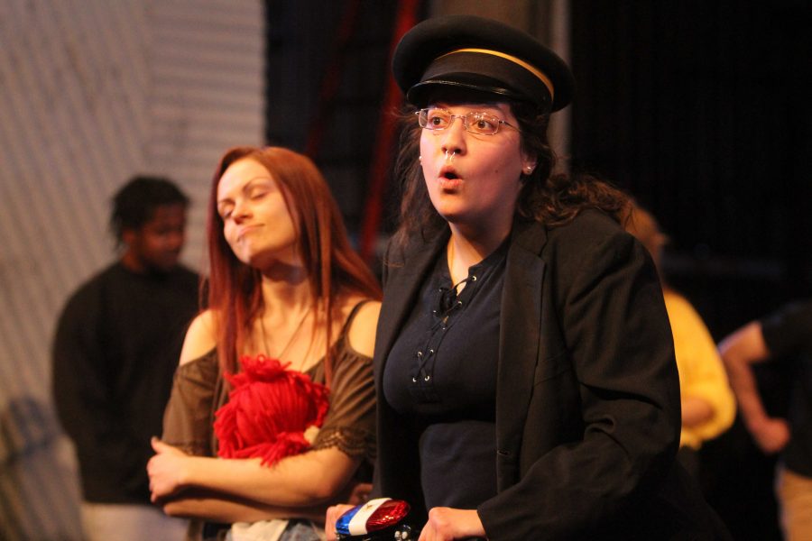 Ellanor Collins who plays Officer Lockstock in the production of Urintetown practices one of the songs at rehersal Feb. 9. Photo by Avery Whaite