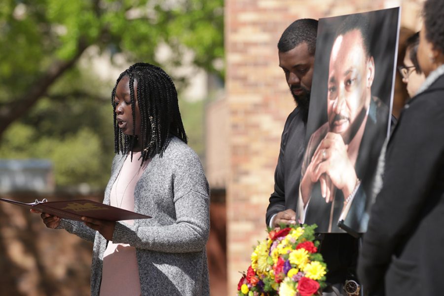 Anissa Jones, exercise physiology junior, reads life works of Martin Luther King Jr. for the 50th anniversary of the assassination of King outside of the CSC, Wednesday, April 4, 2018. Photo by Francisco Martinez