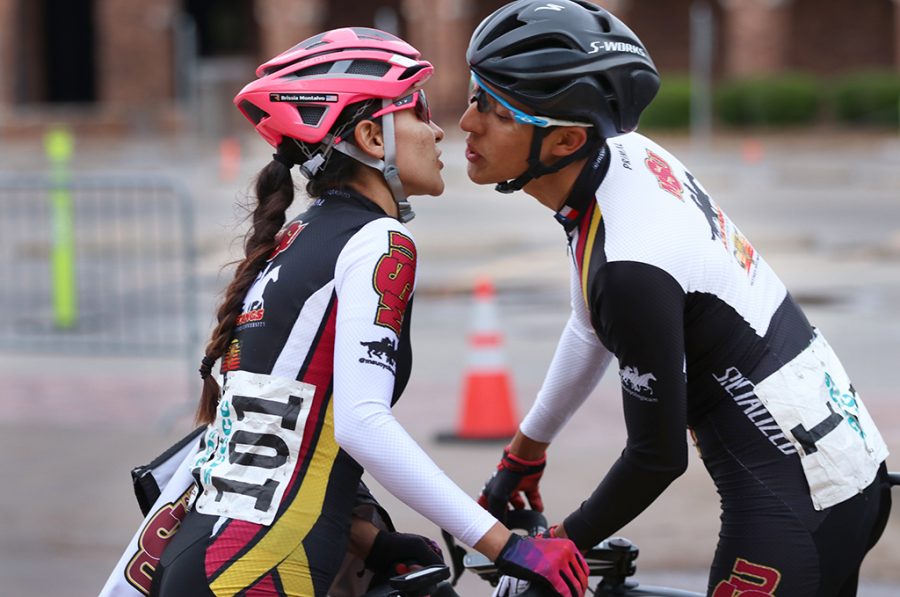Brissia Montalvo, exercise physiology graduate, kisses her boyfriend Pablo Cruz, exercise physiology senior, before his race where he placed third overall in the mens A race at the 2018 Vuelta del Viento at Midwestern State University, Saturday April 21, 2018. Photo by Rachel Johnson