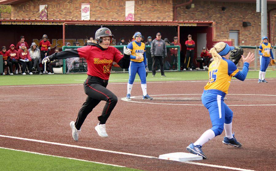 Kelsey Eropkin, psychology sophomore, gets an out running to first base during the game against Angelo State, April 7, 2018. MSU lost to ASU 3-1. Photo by Rachel Johnson