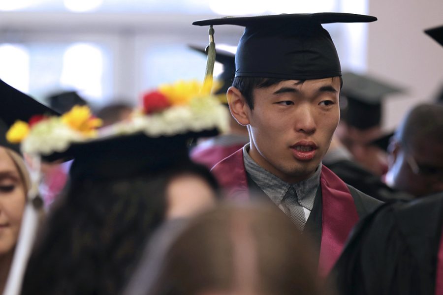 Jiankun Kang, athletic training, waits in line to receive a name card before the Midwestern State University Commencement at Kay Yeager Coliseum on Saturday, May 12, 2018. Photo by Francisco  Martinez