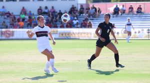 Education sophomore and midfielder Tatum Sharp recieves the ball from Imani Morlock near goals, against New Mexico Highlands University. August 30. Photo by Bridget Reilly